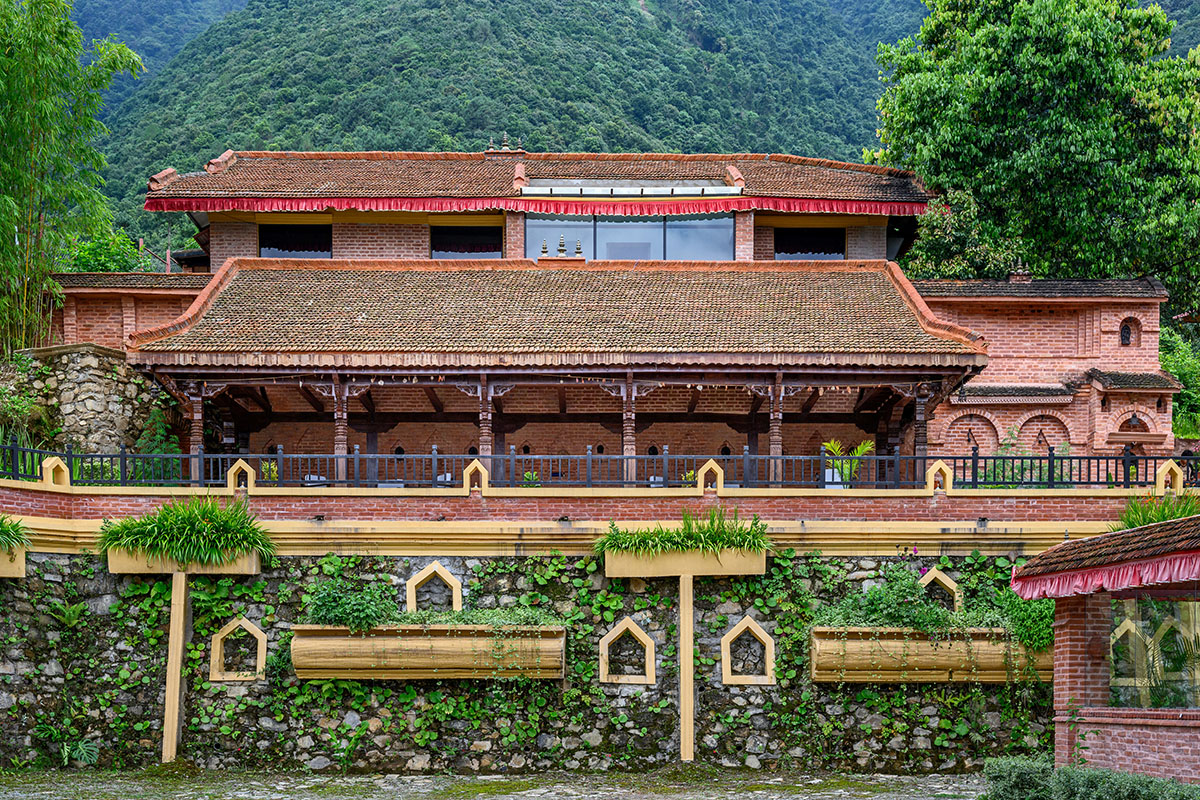 Mindful morning moments with hot tea overlooking lush Nepalese hills